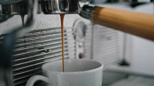 Coffee Brewing Espresso Machine Pouring into White Mug