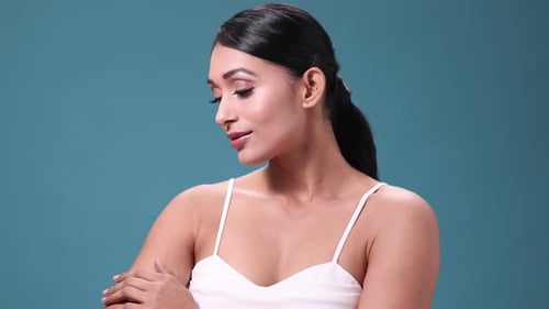 Beautiful Woman Posing in Studio with Blue Background