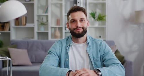 Young Adult Man Sitting at Desk Indoors