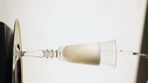 Elegant Champagne Glass Pouring with Bubbly Liquid