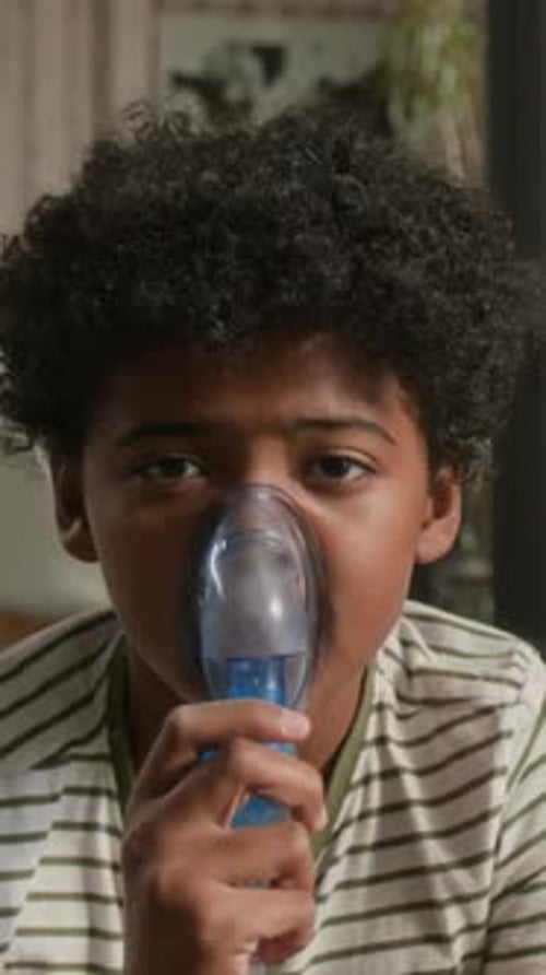 Child Using Inhalation Mask for Respiratory Treatment