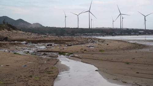 Polluted Beach With Windfarm Seen In Background At Son Hai, Vietnam. Locked Off