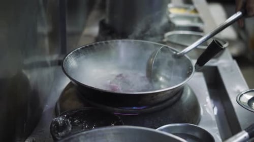 Hand Stirring Boiling Meal In A Pan By Stainless Spoon Ladle In The Restaurant. - High Angle, Slow M