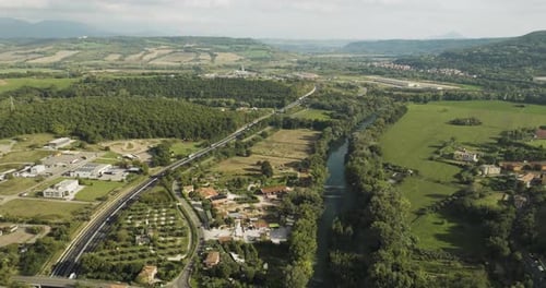 Aerial view of winding highway through greenery, Italy.
