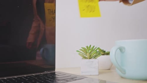 Man Leaving Notes On Computer Screen