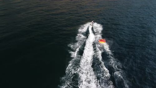 Jet Ski Tows Tube With Friends on Ocean