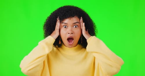 Shock, news and omg with a woman on a green screen background in studio covering her mouth