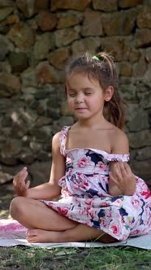 Young Girl Meditating Outdoors in Peaceful Nature Setting