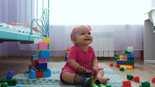 Baby Girl Playing with Toys on Rug