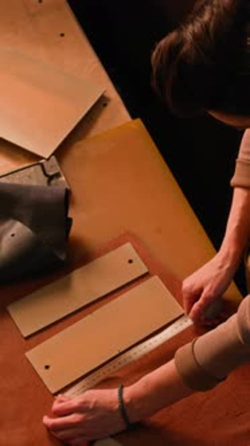 Vertical of Young Craftswoman Working with Leather in Professional Studio