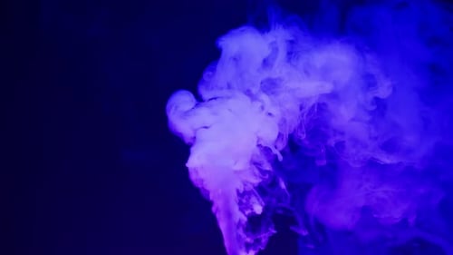 Smoke Texture on Black Background in Blue Neon Light Smoking Steam Clouds of Vapour Closeup Burning