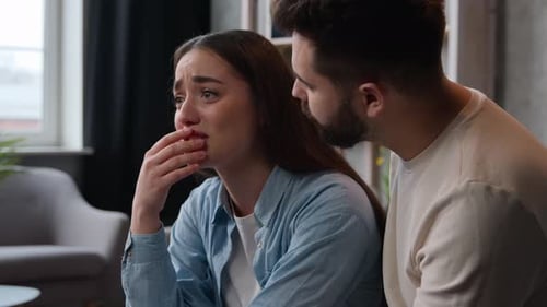 Man Comforting Crying Woman Indoors