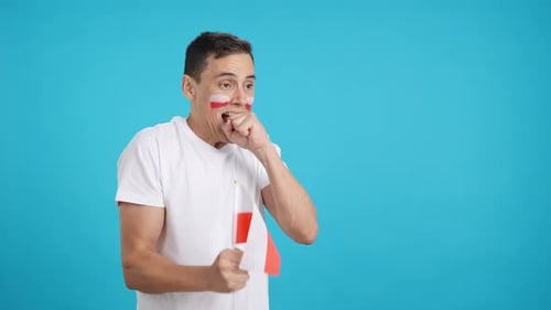 Nervous Man Cheering for Poland During a Match Looking Away