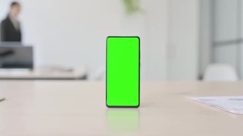 Smartphone with Green Screen on Table