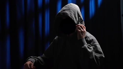 Person in Hooded Sweatshirt on a Phone Call