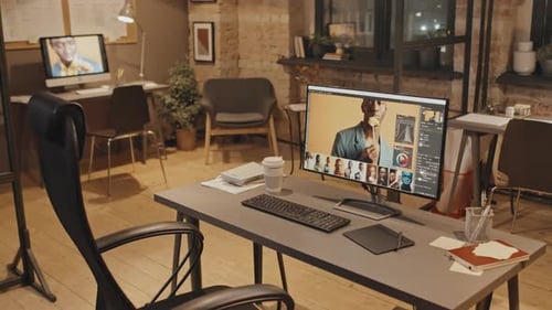 Evening Office Interior with Footage on Screens