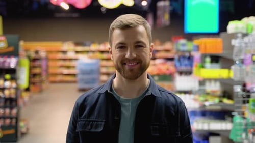 A Man Walks at Grocery Supermarket and Choosing the Right Product