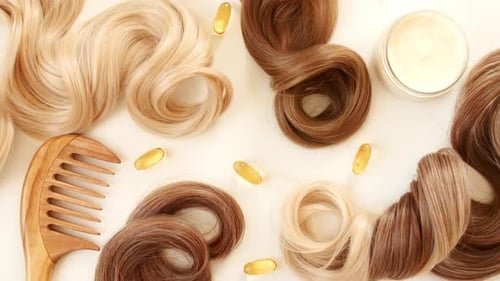 Blond Brown Shiny Wavy Hair on White Background Shiny Woman Hair Strand Curl Hair Care and Beauty
