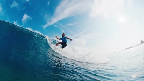 Professional surfer rides the wave and makes aggressive turn