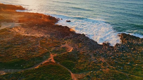 Amazing Sunset Rocky Coast with Foamy Ocean Waves