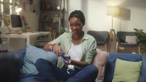 Black Woman Playing Console Game at Home