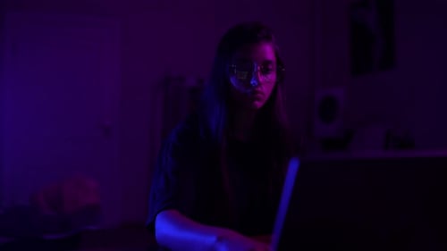 Attractive Young Woman Working in Home at Night