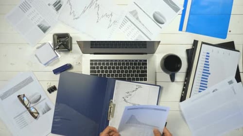 Male Hands of Manager Typing Text on Laptop Keyboard at White Desk Top View Arms of Young