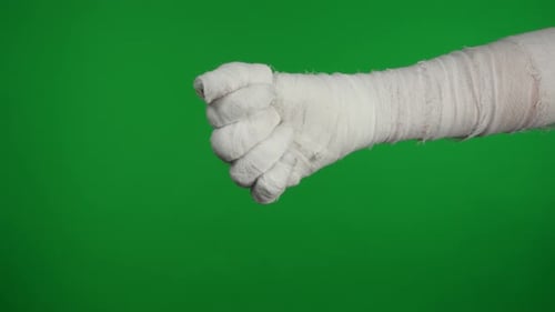 Detail Green Screen Isolated Chroma Key Video Capturing Mummy's Hand Showing in the Frame and Giving