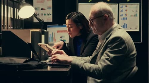 Woman and Man Working Together at Office Desk