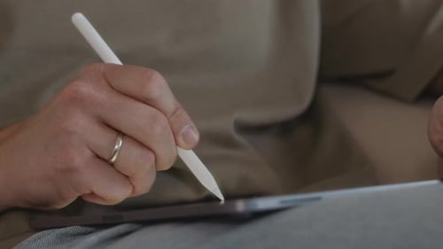 Close Up of Male Hand Drawing with Stylus on Tablet