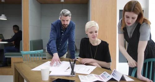 Team Collaboration on Project Plans in Modern Office