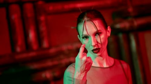 Woman Poses with Dramatic Red and Green Lighting
