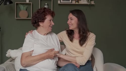 Affectionate Moment Between Woman and Young Adult Indoors