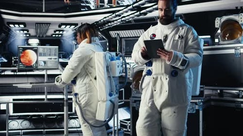 Astronaut Checking Human Expansion to Mars Mission Data on Tablet