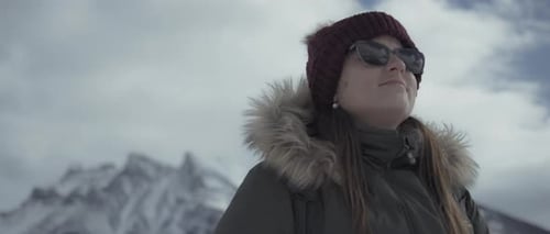 Young hiker walking outdoors in winter surrounded by Rocky Mountains