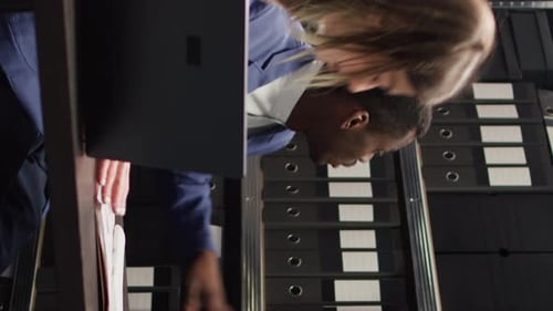 Teamwork: Man and Woman Collaborating in an Office