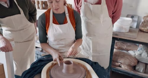 Pottery, group and teacher mold clay in studio or workshop learning with instructor woman