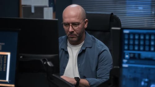 Information Security Expert Working at Computer in Office