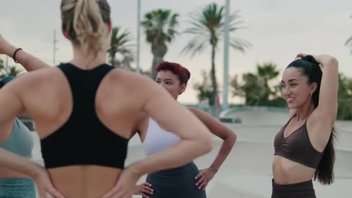 Women Stretch and Prepare to Exercise in Urban Park