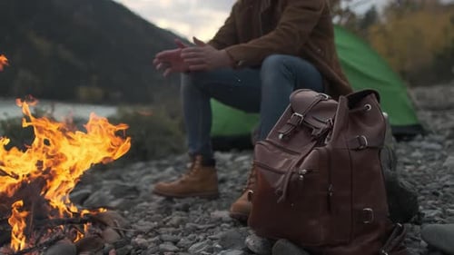 Hiker Tourist Traveler Man with Backpack Mountain Camping Fire Firewood Camp Tent Traveling Hiking