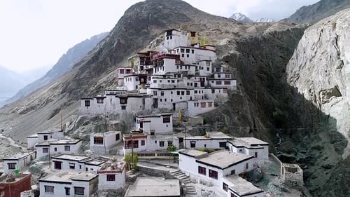 ancient buddhist monastery on a remote rocky mountain region in leh ladakh, india. aerial footage.