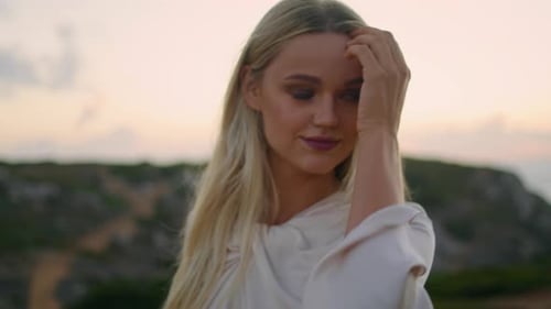Blonde Woman Posing on a Cliff at Sunset