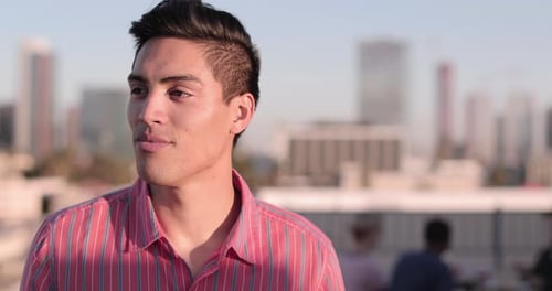 Attractive Young Man Smiles on City Rooftop