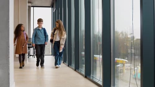 Three Diverse Pupils Walking in a School Corridor