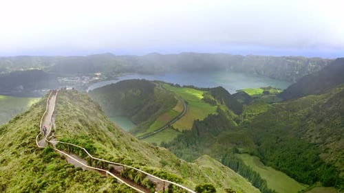 Hiking trail on crest of steep mountain range in mist, Boca de Inferno.