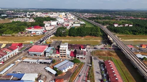 Aerial view shows a river flowing beside a town