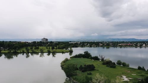 Drone shot flying over Penny Island in the middle of Sloan's Lake.