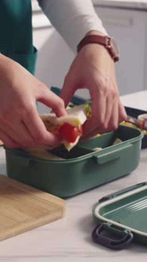 Hands of Unrecognizable Doctor Packing Container with Lunch