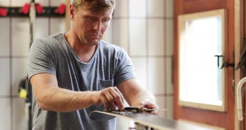 Craftsperson working in snowboard workshop