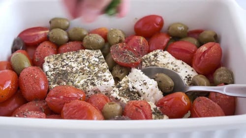 Baked feta cheese with cherry tomatoes and olives.